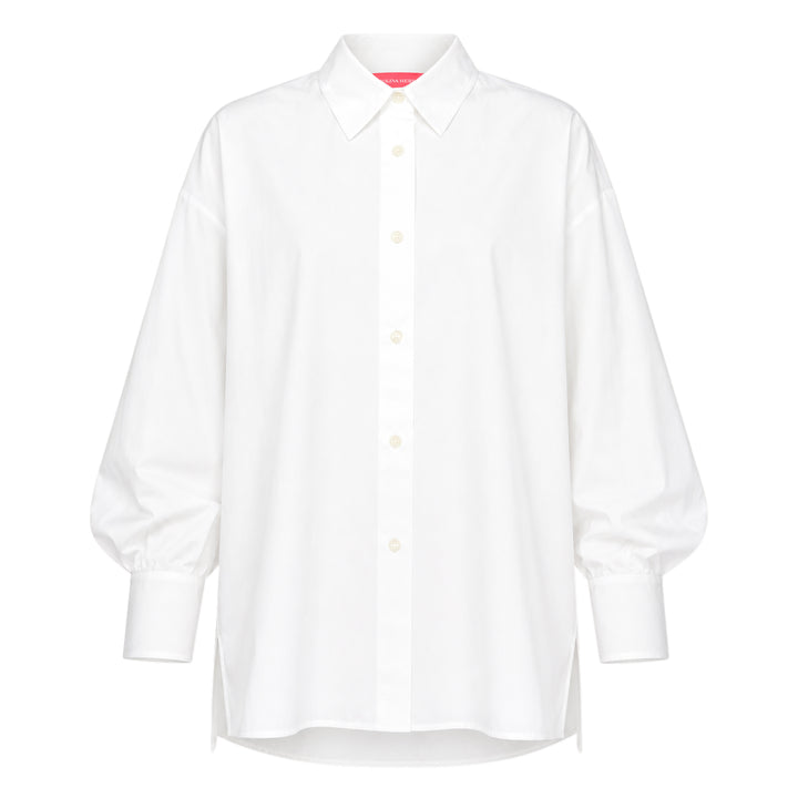 Carolina Herrera Clara Shirt in white cotton with voluminous bishop sleeves, point collar, and pearlescent button-front placket, displayed flat on a white background