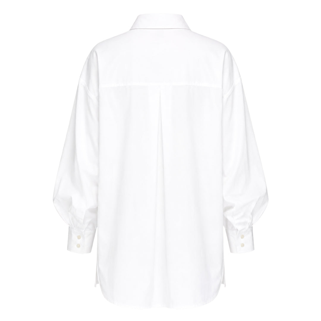 Carolina Herrera Clara Shirt in white cotton with voluminous bishop sleeves, point collar, and pearlescent button-front placket, displayed flat on a white background