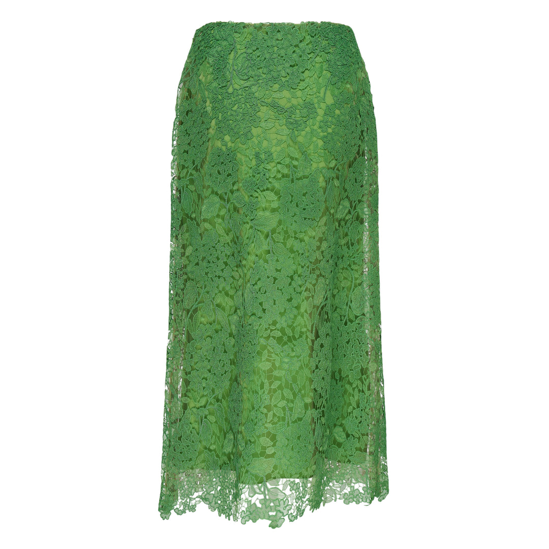 Carolina Herrera green floral guipure lace midi skirt with scalloped hem, pencil silhouette, and slip lining, shown flat against a white background