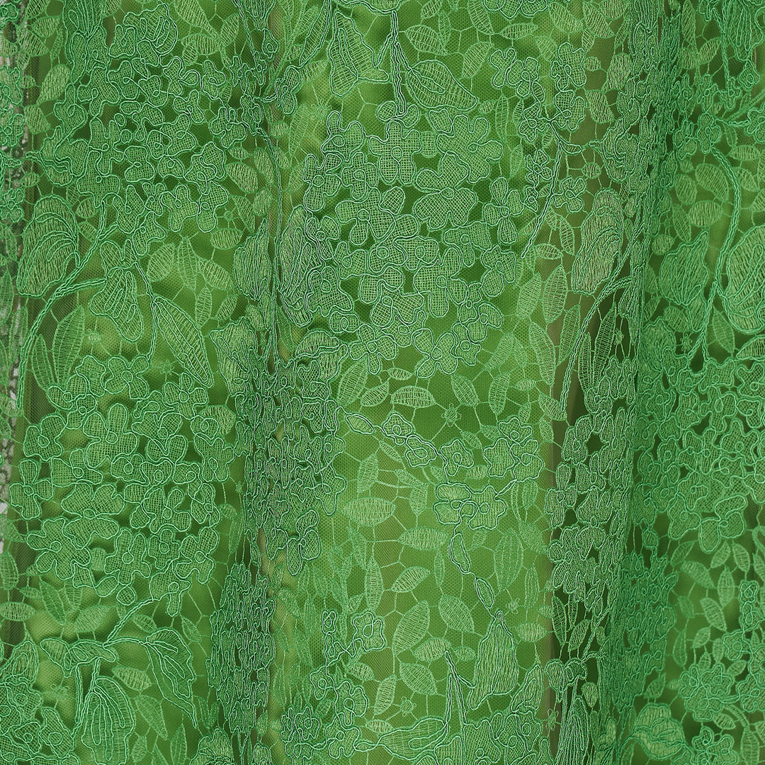 Carolina Herrera green floral guipure lace midi skirt with scalloped hem, pencil silhouette, and slip lining, shown flat against a white background