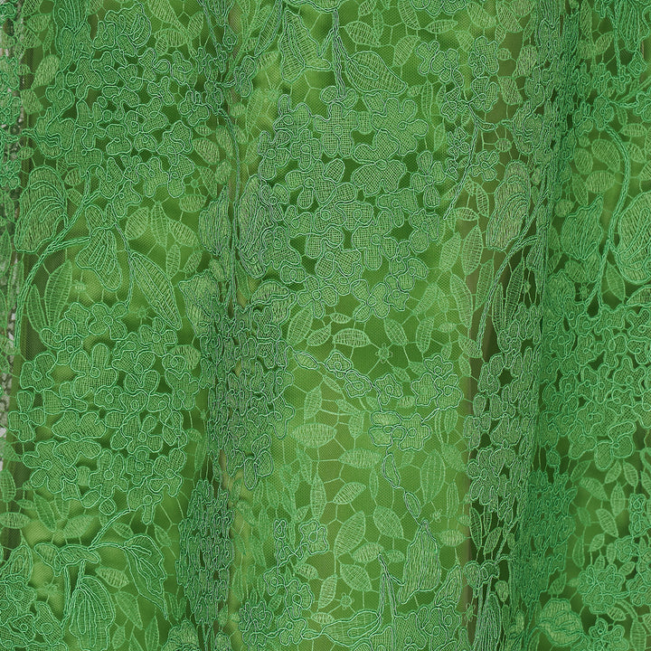 Carolina Herrera green floral guipure lace midi skirt with scalloped hem, pencil silhouette, and slip lining, shown flat against a white background