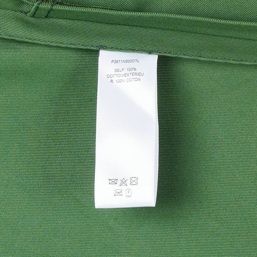 Carolina Herrera forest green short sleeve crew neck A-line midi dress with self-fabric belt, gold-tone buckle, geometric topstitch detail on the bodice, and patch pockets on the flared skirt