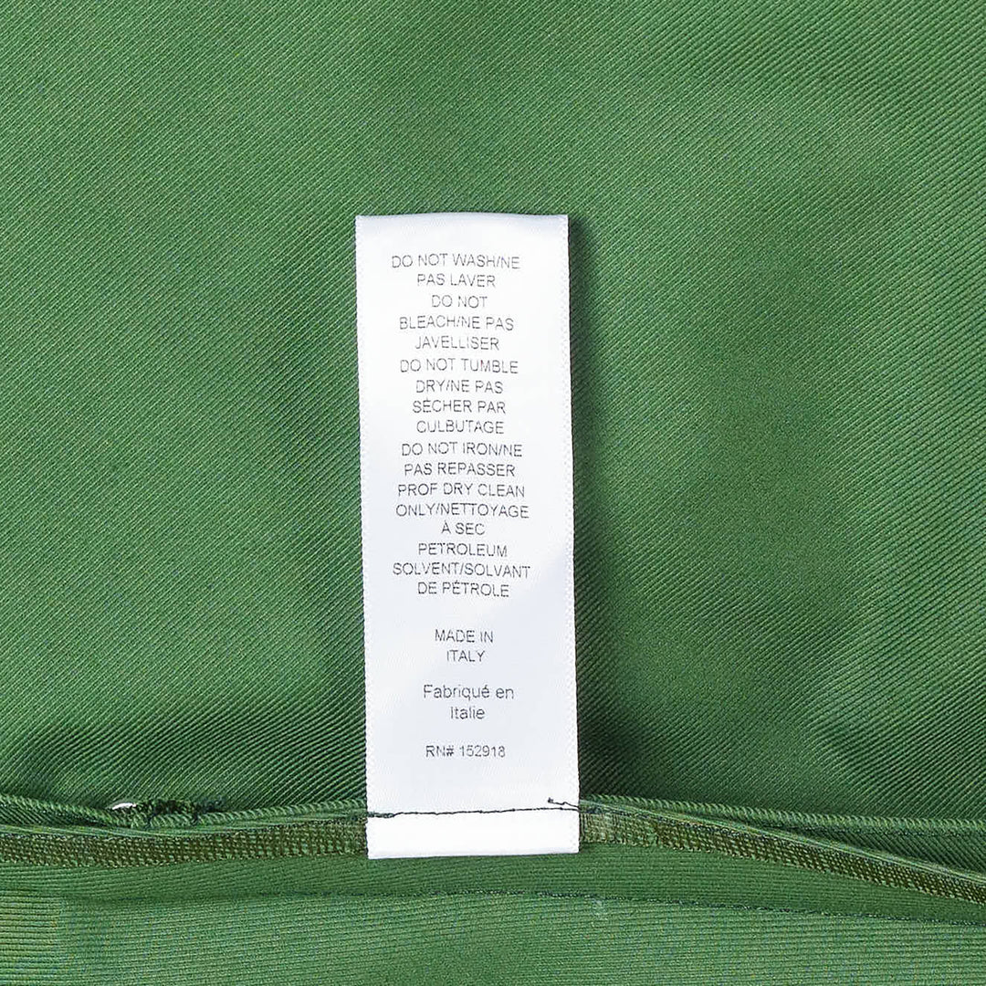 Carolina Herrera forest green short sleeve crew neck A-line midi dress with self-fabric belt, gold-tone buckle, geometric topstitch detail on the bodice, and patch pockets on the flared skirt