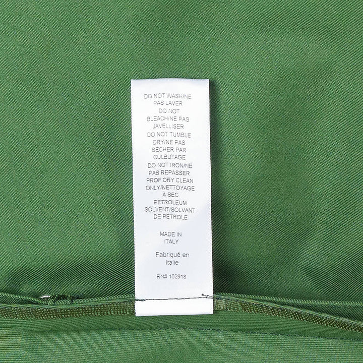 Carolina Herrera forest green short sleeve crew neck A-line midi dress with self-fabric belt, gold-tone buckle, geometric topstitch detail on the bodice, and patch pockets on the flared skirt