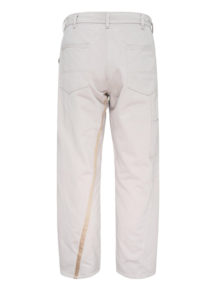 Maison Margiela stone cotton pants with a twisted seam and contrast tan tape trim, shown from the front - view 2