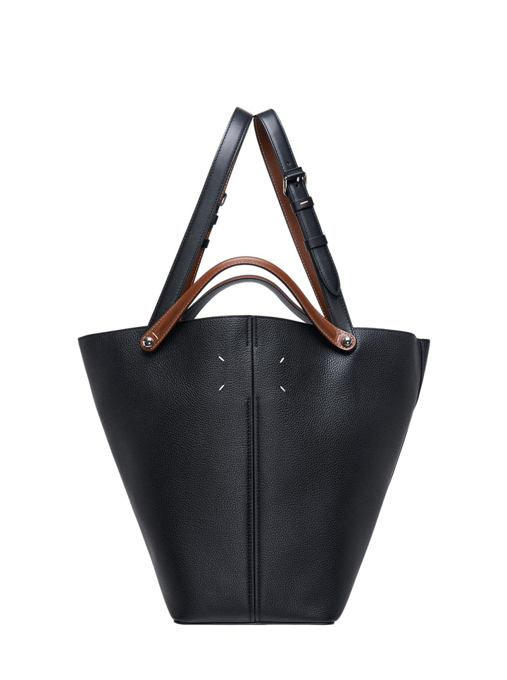 Maison Margiela Dress-Age medium tote in black grained leather with tan handles, adjustable shoulder strap and white four-stitch detail