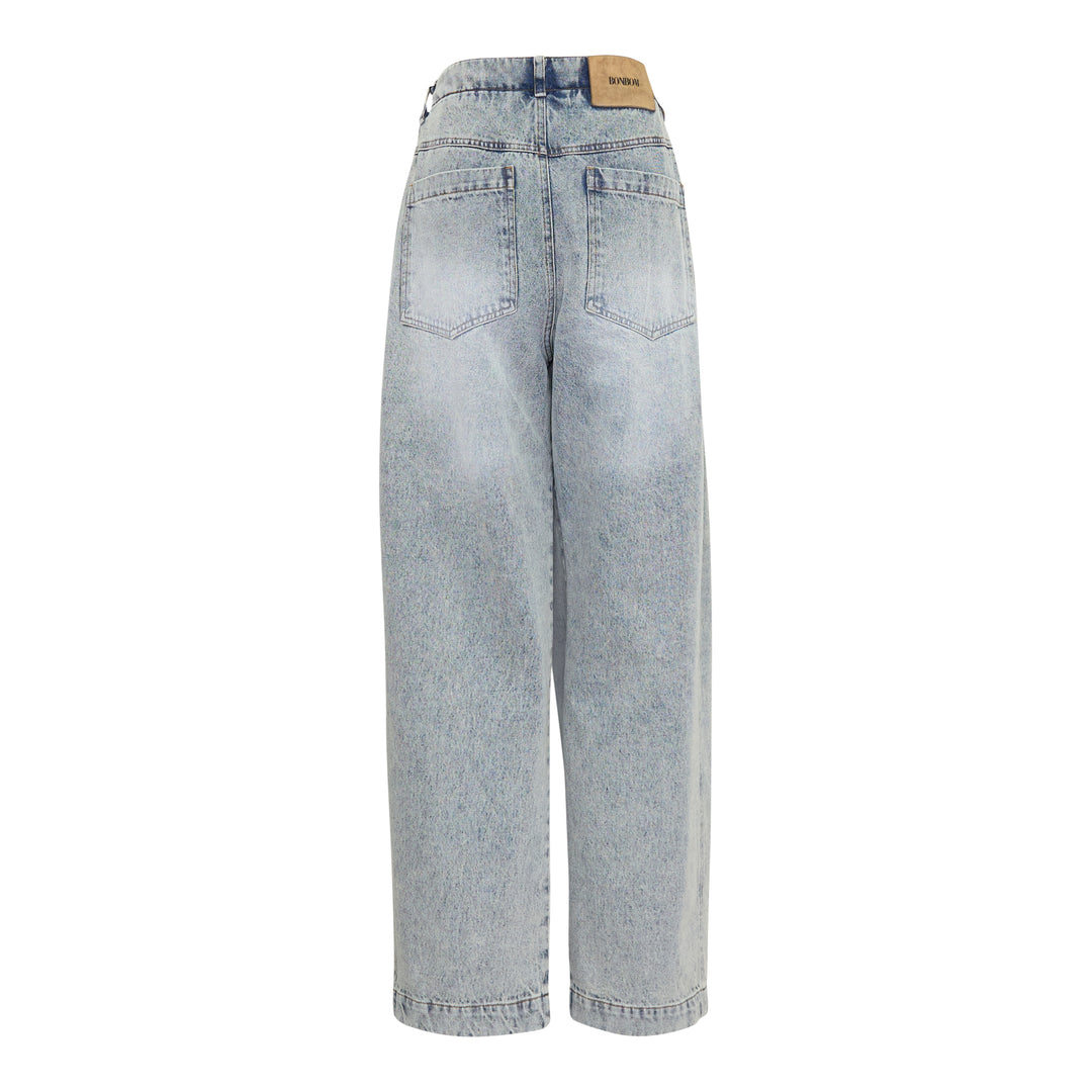 Bonbom Giant Front-Volume Tuck Jeans in light acid-wash denim, featuring sculptural front tuck pleats, a barrel-leg silhouette, and an elasticated waistband, styled flat on a white background