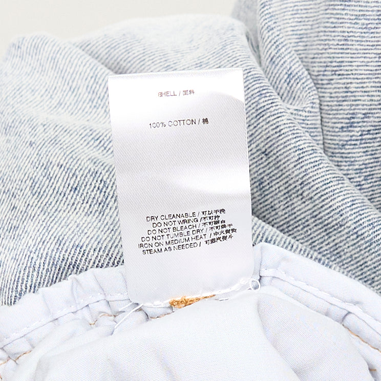 Bonbom Giant Front-Volume Tuck Jeans in light acid-wash denim, featuring sculptural front tuck pleats, a barrel-leg silhouette, and an elasticated waistband, styled flat on a white background