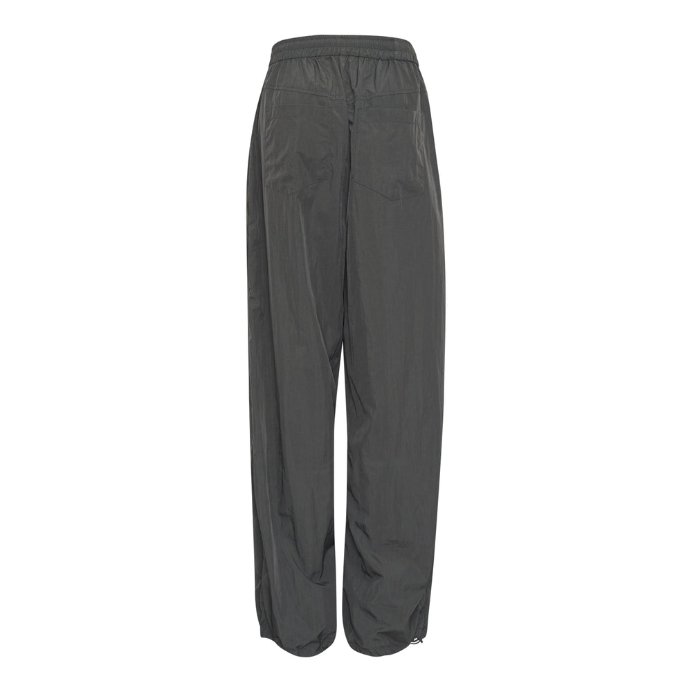 Bonbom Two-Tuck Track Pants in dark grey crinkle nylon, featuring a wide-leg silhouette, elasticated waistband, and sculptural front tuck detailing