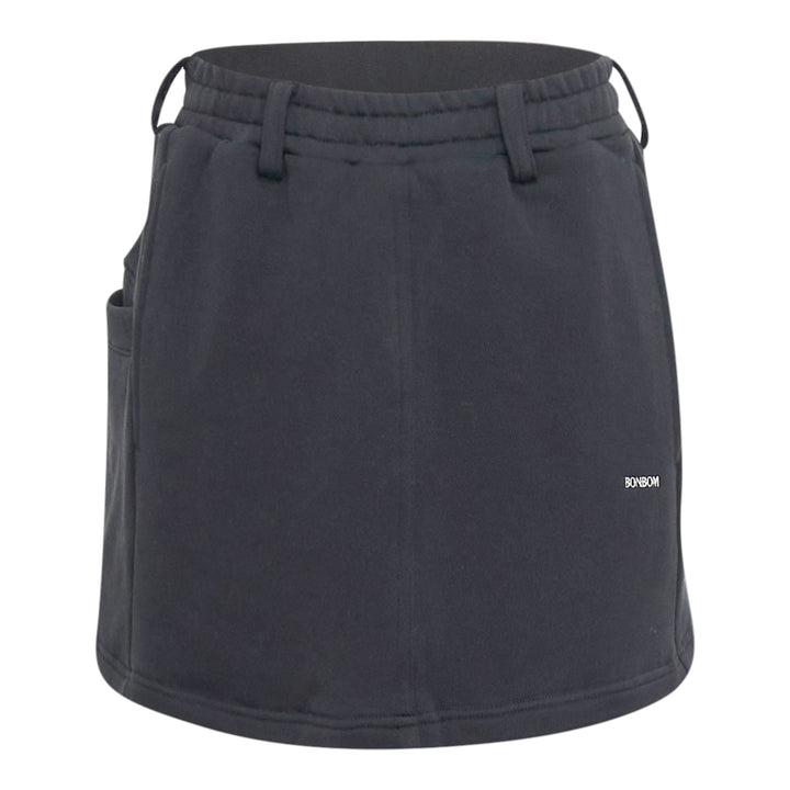Bonbom Giant Front-Volume Mini Skirt in washed dark navy heavyweight fleece, featuring an elasticated drawstring waistband, belt loop detailing, side patch pocket, and a small woven Bonbom logo label at the lower front