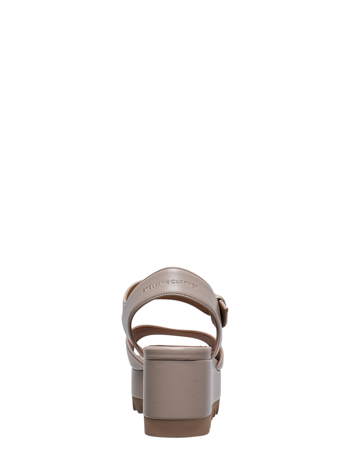 Stella McCartney Elyse Alter Mat flatform sandal in taupe, featuring a wide toe strap, adjustable ankle strap with gold buckle, and signature serrated platform sole, shown in profile view - view 3