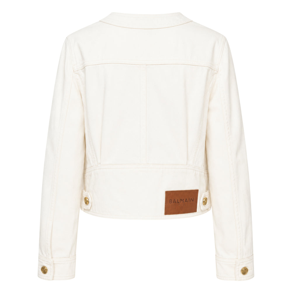 Balmain white denim collarless jacket with four patch pockets and gold-tone embossed logo buttons, front view - view 2