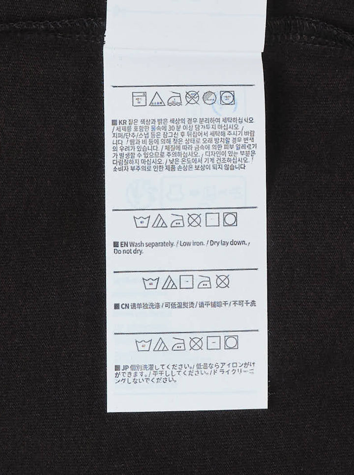 thisisneverthat Saturn short sleeve tee in washed black with a small woven brand logo label at the chest and a ribbed crewneck collar, displayed flat on a white background - view 3