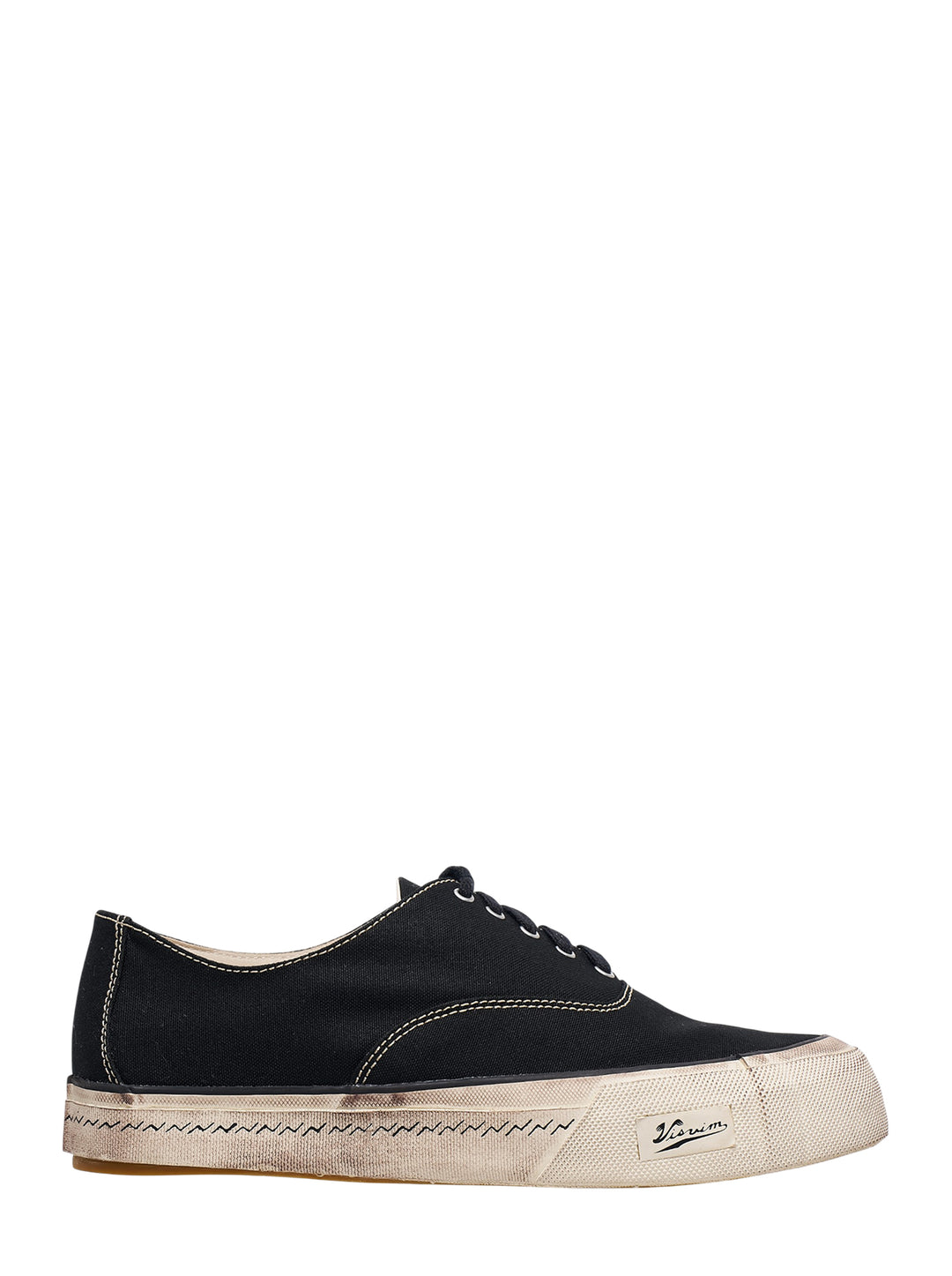 visvim Logan Deck Lo black canvas sneaker with contrast stitching and distressed off-white sole, side view