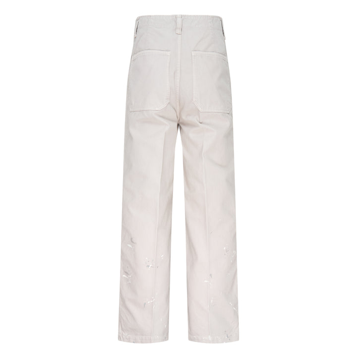 visvim Survey Damaged Pants in light stone, wide-leg silhouette with paint-splatter distressing on lower leg panels, front view on white background - view 2