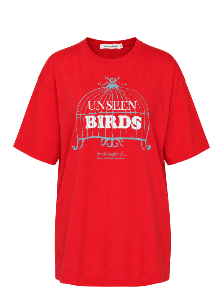 Red oversized Undercover short-sleeve tee with a blue birdcage illustration and white 'Unseen Birds' lettering on the chest
