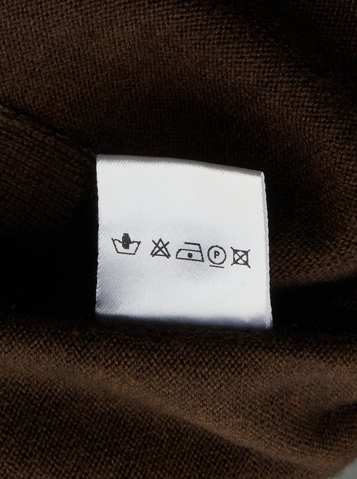 Sonia Carrasco Knit Polo Sweater in dark chocolate brown with contrast white overlock stitching along the seams, polo collar, four-button placket, and diagonal front pockets - view 3