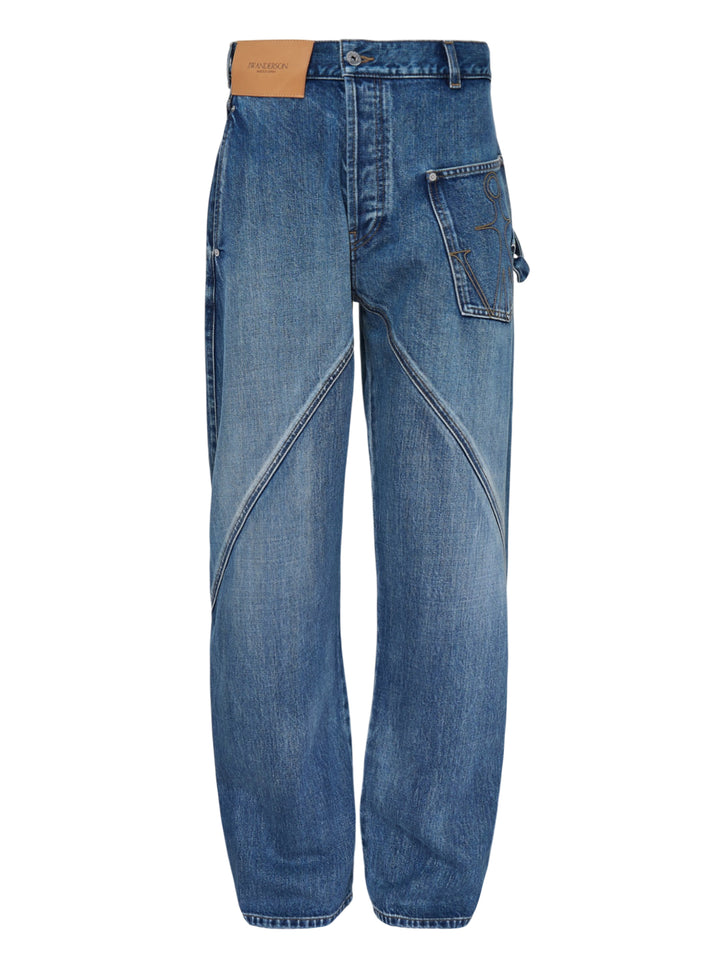 JW Anderson Twisted Workwear Jeans in washed blue denim with curved twisted seams, embroidered front pocket and leather logo patch at the waistband