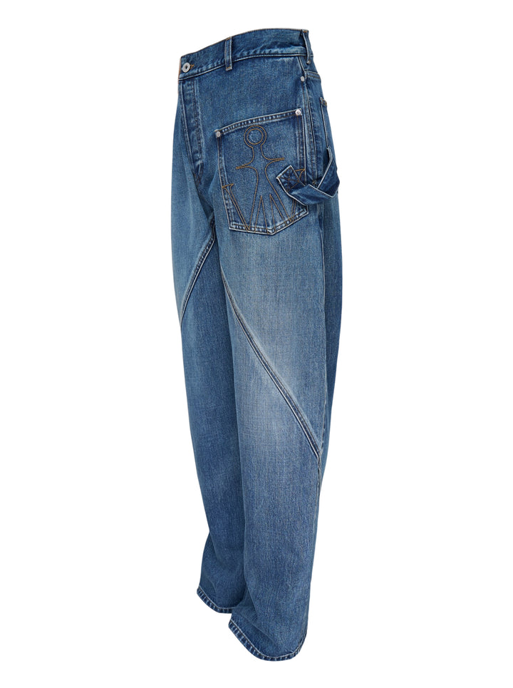 JW Anderson Twisted Workwear Jeans in washed blue denim with curved twisted seams, embroidered front pocket and leather logo patch at the waistband - view 2