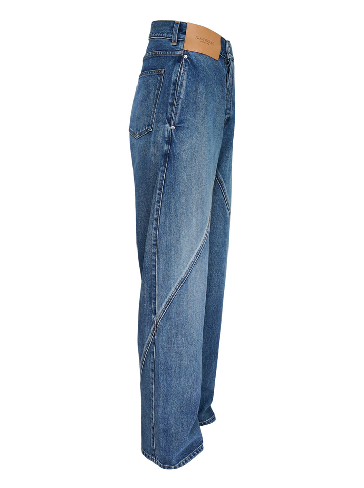 JW Anderson Twisted Workwear Jeans in washed blue denim with curved twisted seams, embroidered front pocket and leather logo patch at the waistband - view 4