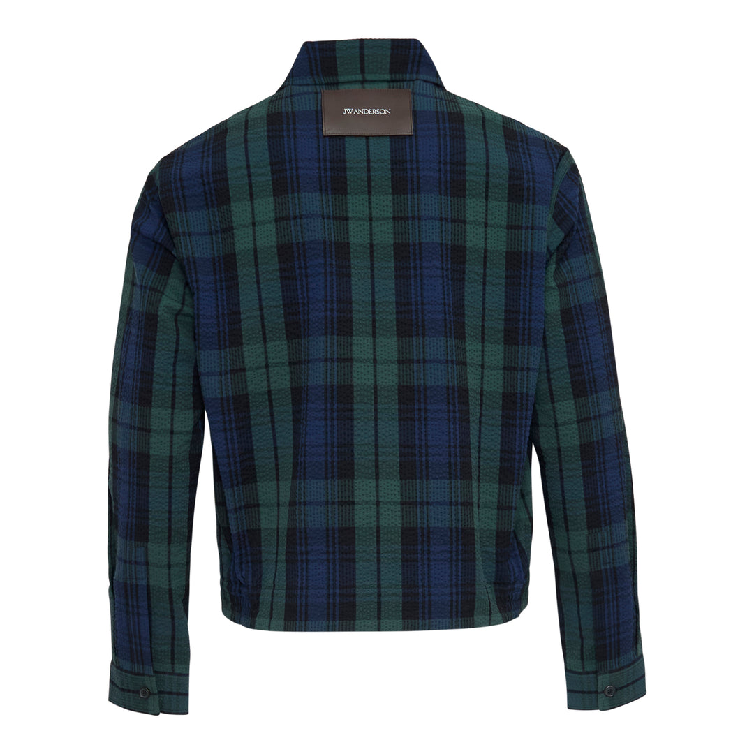 JW Anderson Front Zip Blouson in Black Watch tartan cotton seersucker, featuring a spread collar, gold-tone zip closure, and angled hip pockets
