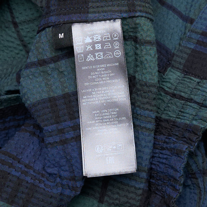 JW Anderson Front Zip Blouson in Black Watch tartan cotton seersucker, featuring a spread collar, gold-tone zip closure, and angled hip pockets