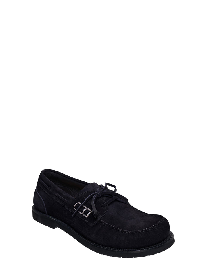 JW Anderson black suede boat loafer with lace-up vamp, silver ring hardware, and chunky ridged rubber outsole, shown in profile view - view 2