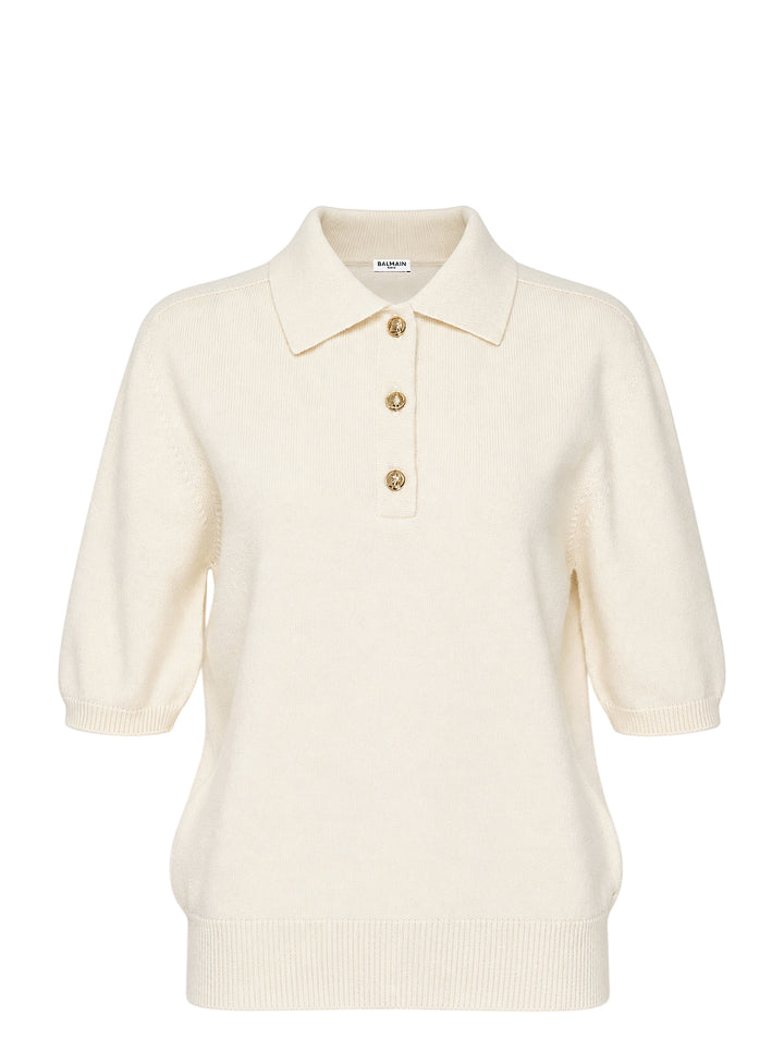 Balmain short sleeve cashmere knit polo in cream with a ribbed collar and three gold-tone embossed buttons