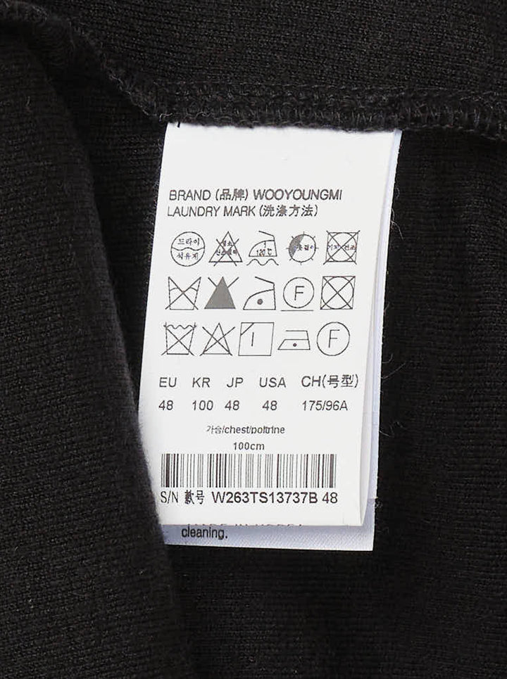 Wooyoungmi Oversized Textured Polo in black, featuring an open-placket collar, boxy short-sleeve silhouette, chest patch pocket with tonal WM monogram badge, and side hem vents - view 3