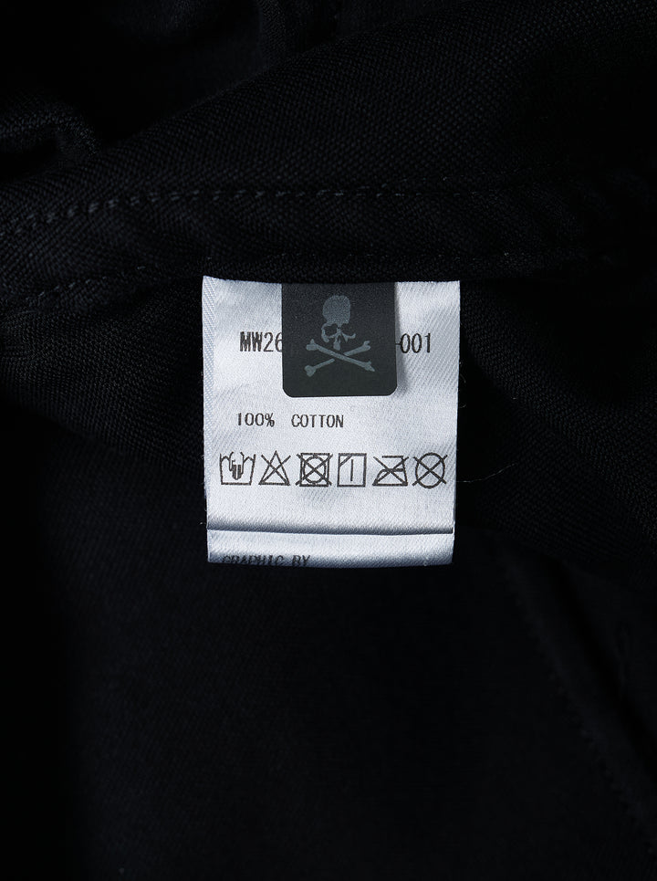 Mastermind Doodle Print Easy Pants in black with all-over graphic prints including skull-and-crossbones, yin-yang symbol, kanji script, and hand-scrawled text, featuring an elasticated drawstring waistband and tapered leg - view 3