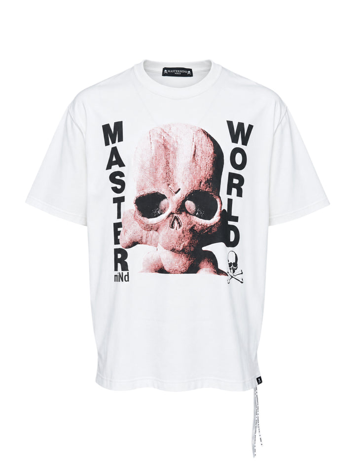 Mastermind World Skull Kid white short sleeve tee with pink skull-and-crossbones graphic and black vertical lettering