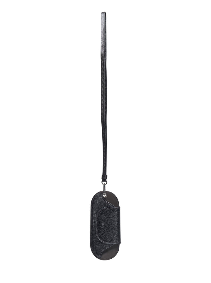 Lemaire Bell Glasses Holder in black pebbled leather with an oval silhouette, snap-fastened front pocket, and long leather lanyard with silver-tone clip