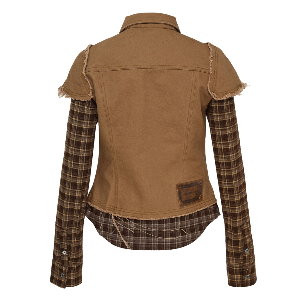 Andersson Bell Layered Studded Vest Shirt — cropped khaki denim vest with silver dome studs and frayed edges over a long-sleeve brown tartan plaid shirt, snap-button front closure and ADSB logo patch