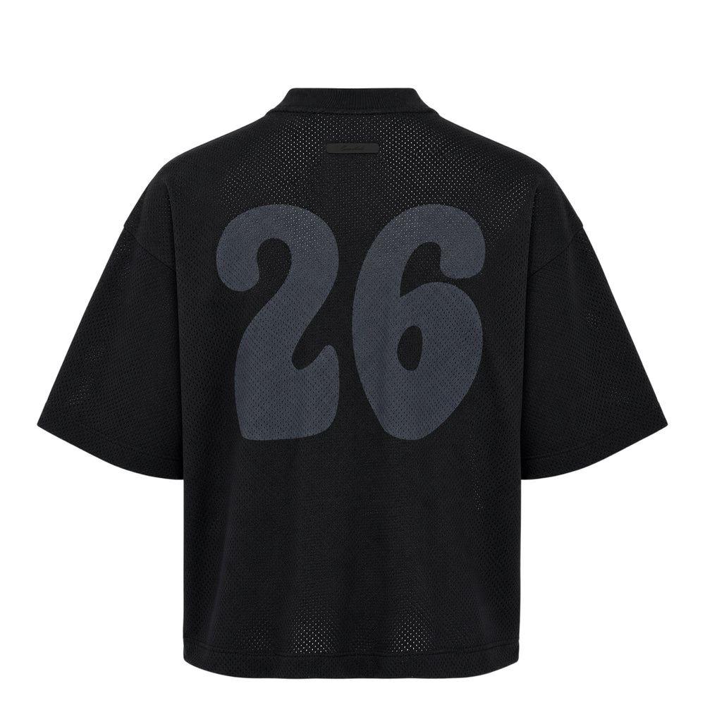 Fear of God Essentials All Valley Essentials Merch Tee in black, featuring a perforated mesh fabric, tonal arch graphic across the chest, and an oversized boxy silhouette with a ribbed mock-neck collar