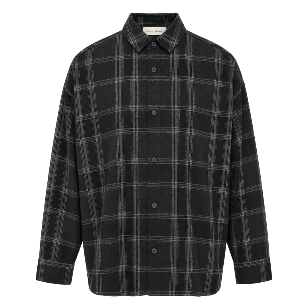 Fear of God Essentials long sleeve plaid button-up shirt in dark navy and grey windowpane check, relaxed oversized fit with concealed placket and tonal buttons, flat lay on white background