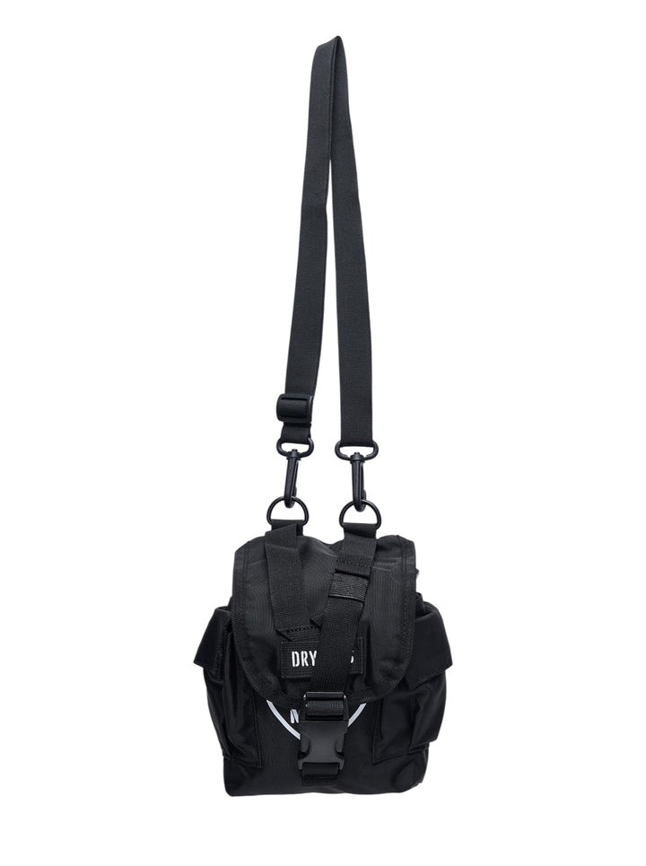 Human Made Military Pouch #1 in black nylon, featuring woven webbing harness, dual D-ring attachments, buckle-release closure, and a detachable adjustable shoulder strap, shown on a white background
