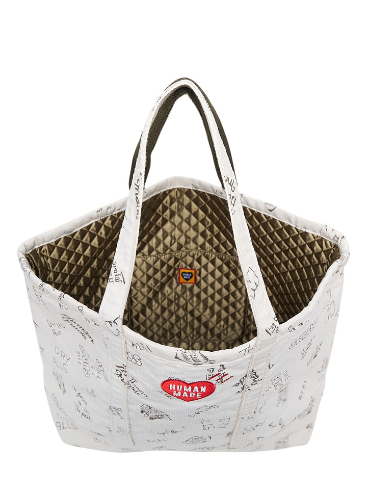 Human Made ivory corduroy tote bag with all-over hand-drawn Dry Alls graphics and an embroidered red heart logo - view 3