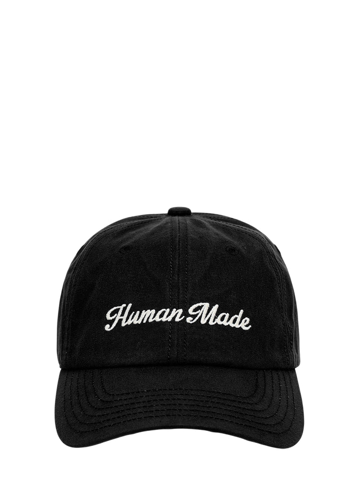 Human Made black 6-panel canvas cap with cream script logo embroidery on the front, shown from the front view