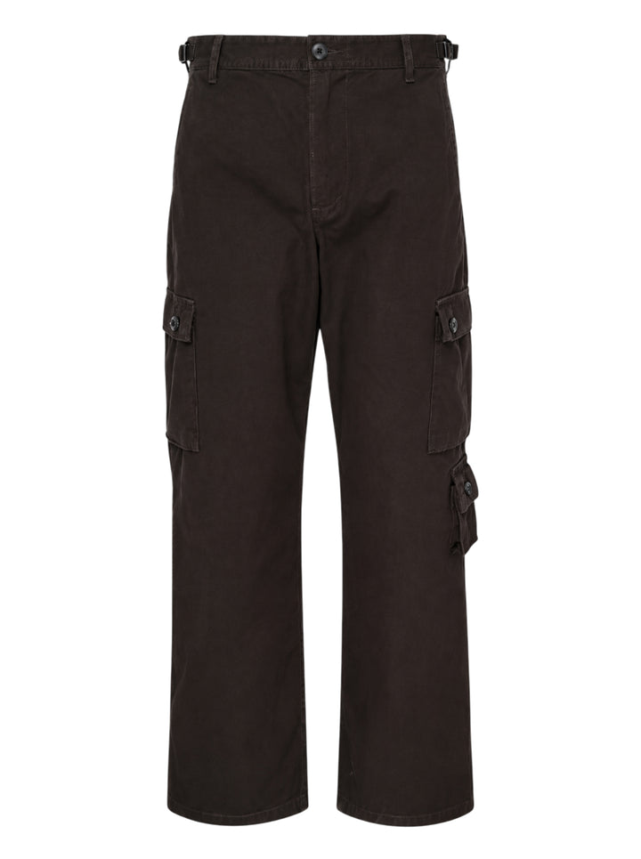 Human Made multi-pocket cargo pants in dark espresso brown, featuring a wide-leg silhouette, buckle waistband, and multiple buttoned utility cargo pockets