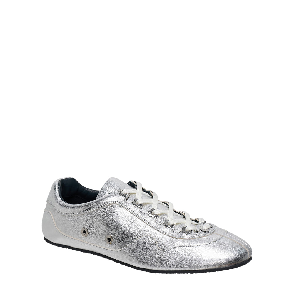 Cecilie Bahnsen silver metallic leather sneaker with black floral stud embellishments scattered across the upper and cream laces, low-profile flat sole, side view