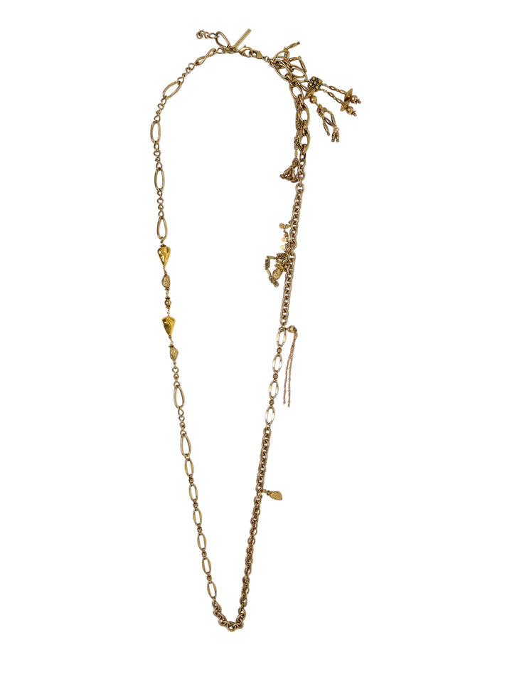 Dries Van Noten long mixed chain charm necklace in antique gold-tone, featuring oval and rolo chain links with an asymmetric cluster of eclectic charms and a toggle clasp closure