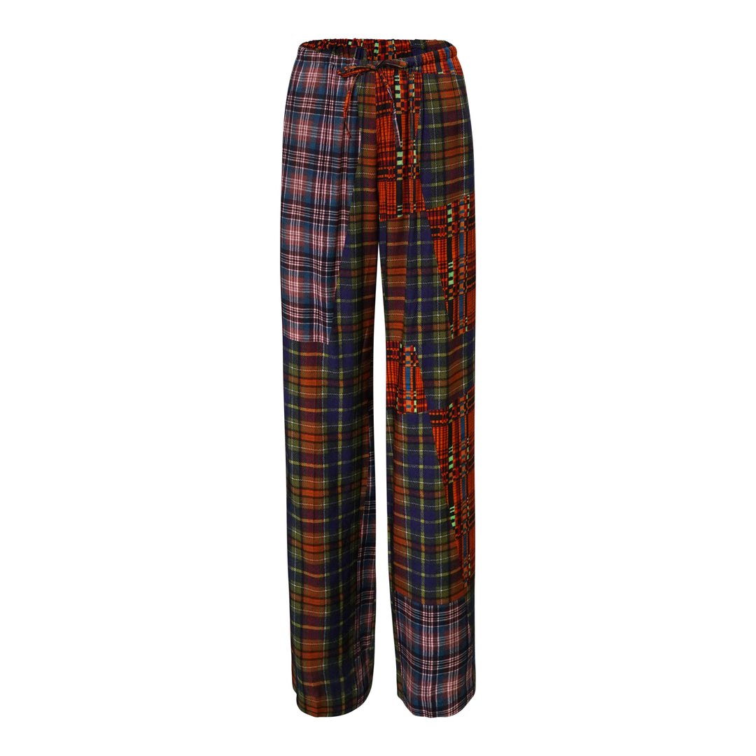 Dries Van Noten patchwork plaid straight-leg trousers featuring mixed tartan and check panels in red, navy, and green tones with an elasticated drawstring waist