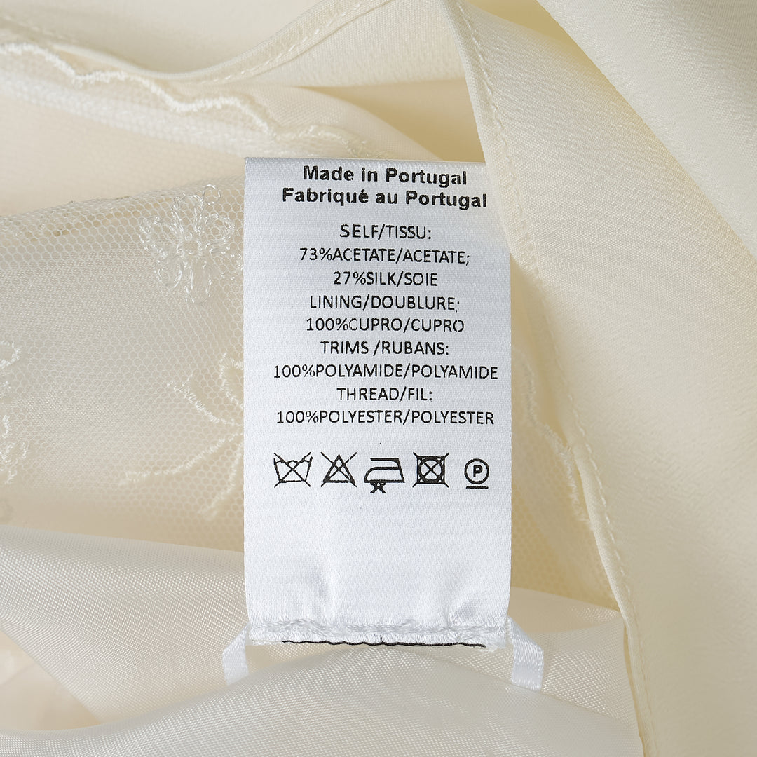 Simone Rocha ivory crepe negligee midi skirt with elasticated waist and floral embroidered lace scalloped hem trim, flat lay on white background