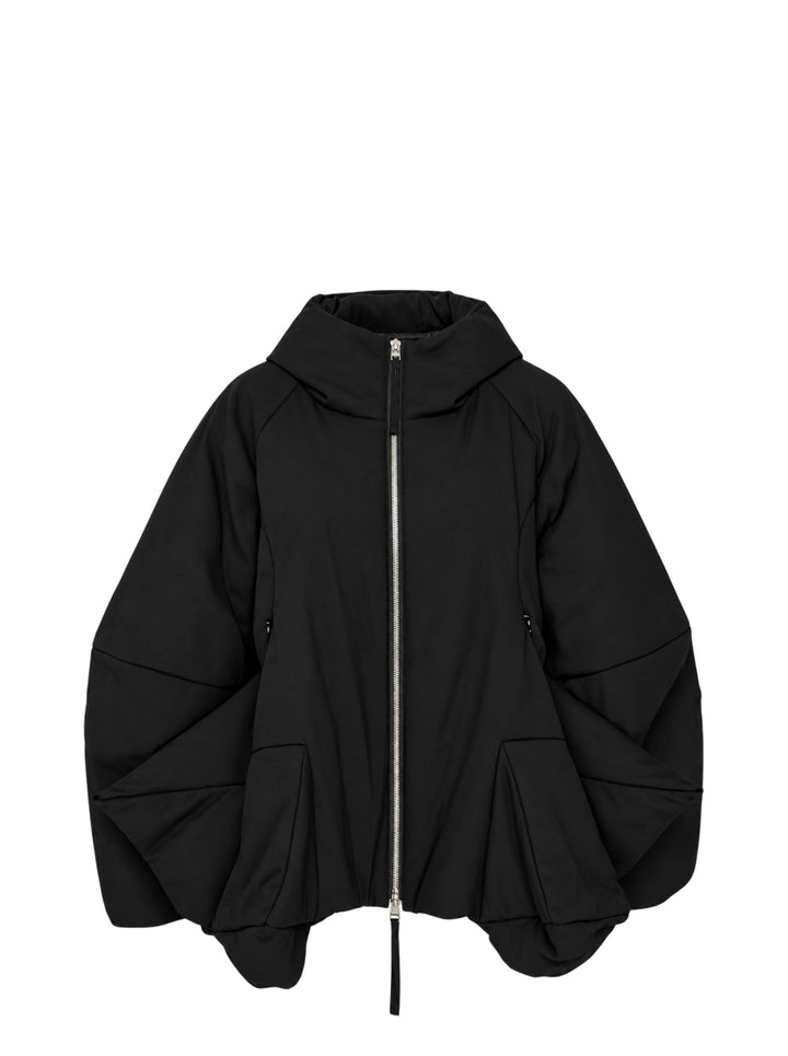 Enfold 3D Hem Hooded Coat in black, featuring a voluminous balloon hem, padded sculptural sleeves, full-length silver zip closure, and attached hood, displayed flat on a white background