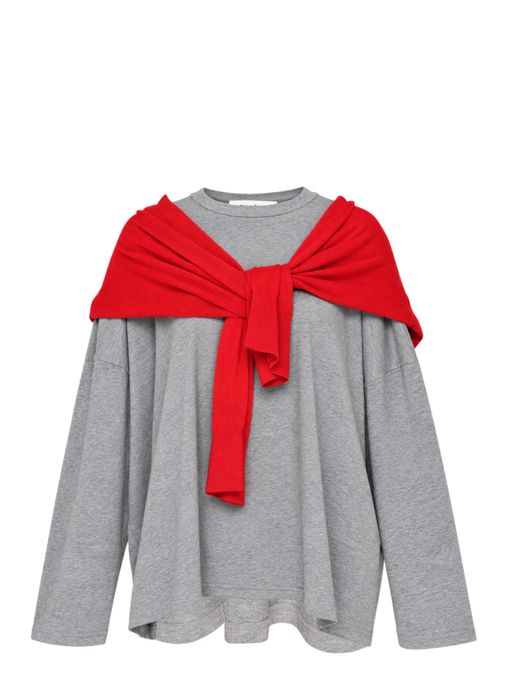 Enfold oversized grey marl long sleeve tee with attached red knitted cape draped over both shoulders and tied in a knot at the chest, styled flat on a white background