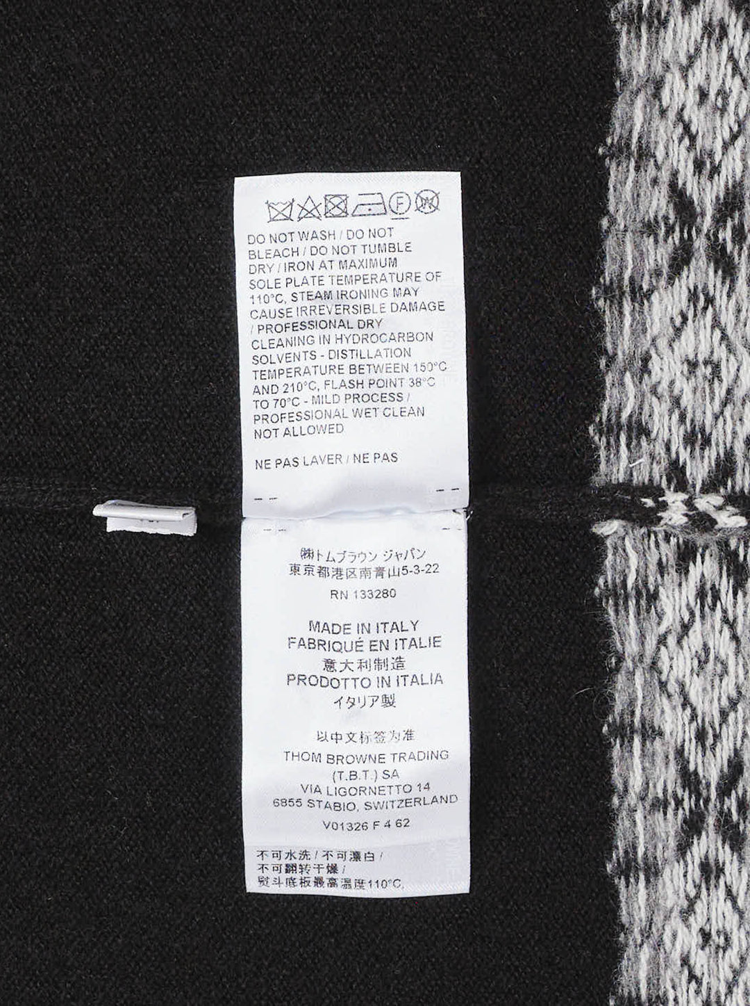 Black sleeveless turtleneck knit vest with white and grey Icelandic Fair Isle snowflake pattern across the yoke and hem - view 4