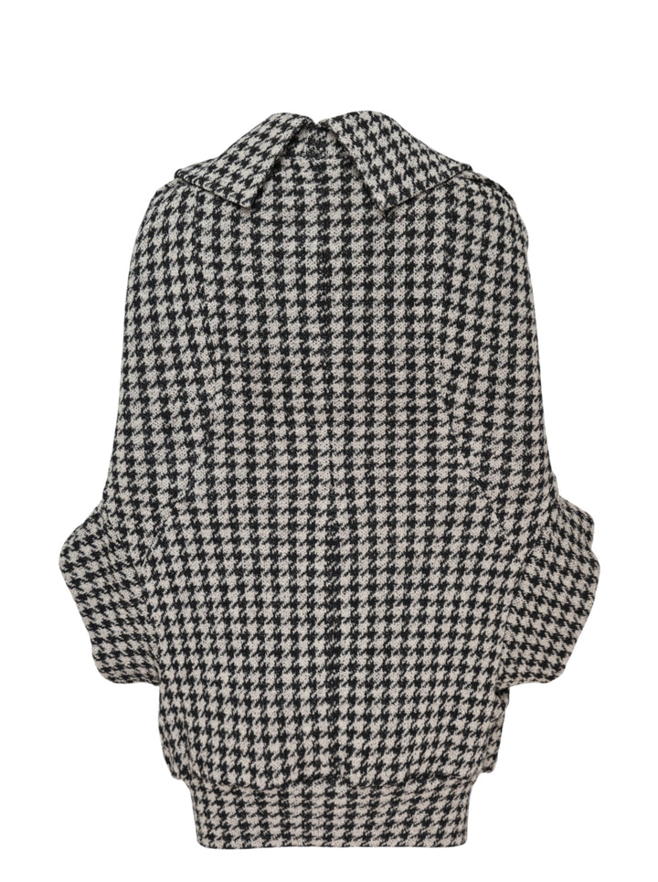 Junya Watanabe black and white houndstooth double-breasted structured coat with oversized silhouette, four black buttons, and large hip pockets, flat lay on white background - view 2