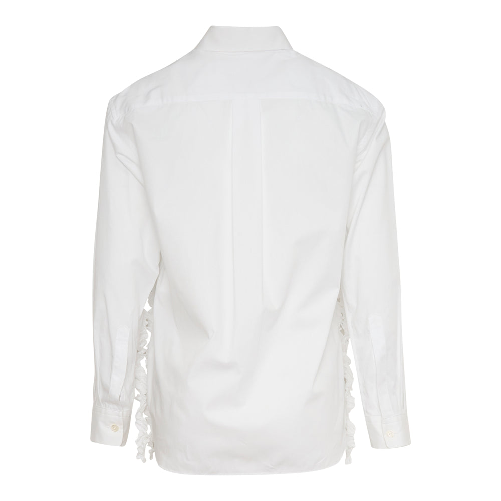 Tao white long-sleeve blouse with cascading textured ruffle strips across the front panel, point collar, and mother-of-pearl button fastening