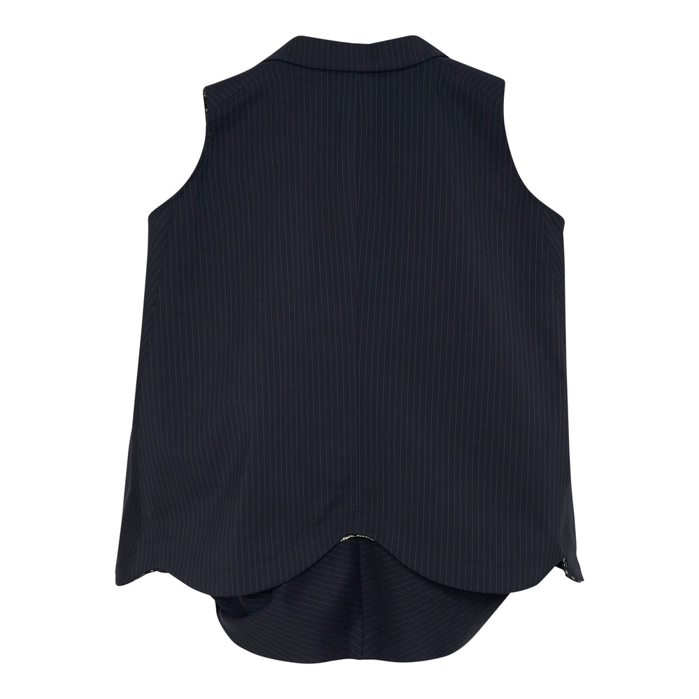 Tao sleeveless navy pinstripe vest with notched lapel, three black buttons, flap chest pockets, exaggerated A-line silhouette, and black floral lace panel at the hem and inner lining, photographed flat on a white background