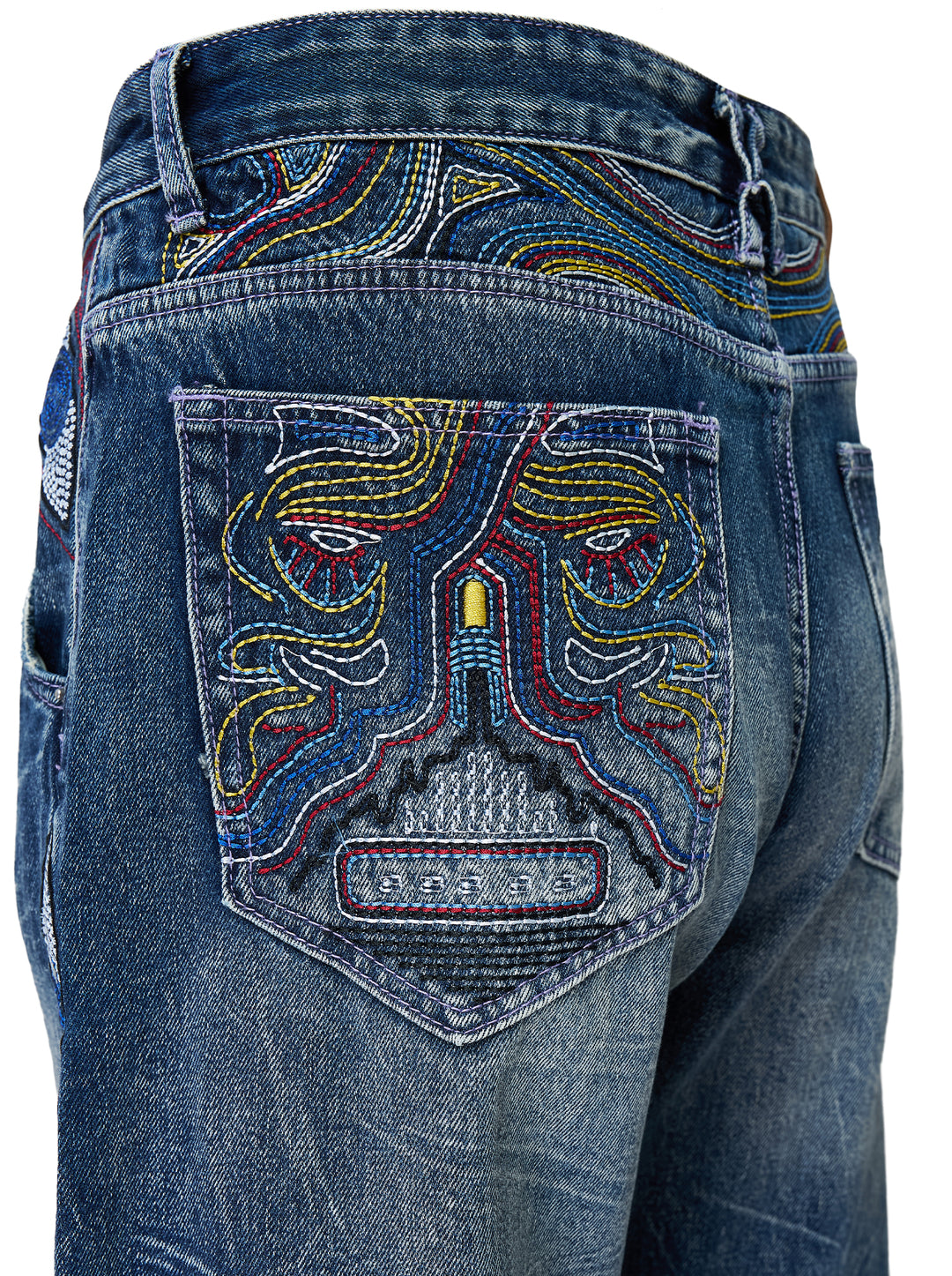 KidSuper Studios Gemstone Eye Embroidery Jeans in faded indigo denim with beaded eye embroidery along both outer legs, shown from the front - view 4
